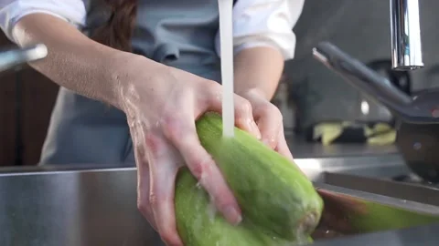 Chef washes zucchini for vegetable ragout Stock Footage 143780315