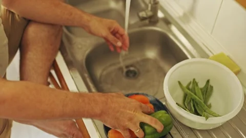 Chef washing fresh vegetables in kitchen sink Stock Footage 307959431