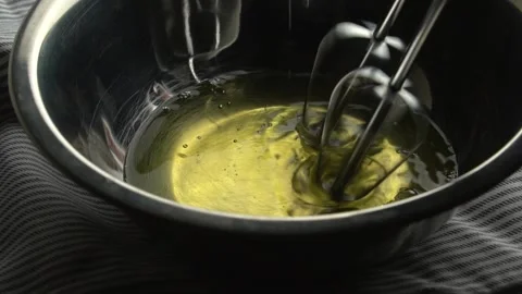 The chef whips the egg with a hand mixer. Stock Footage 140974191