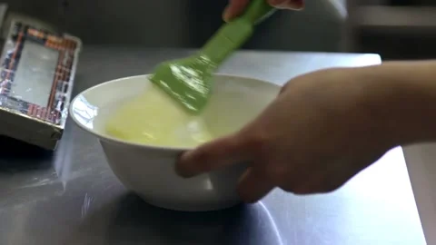 Chef whips eggs by corolla in soup plate Stock Footage 143780306