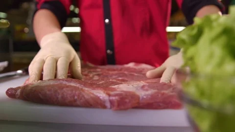 Chef whips a piece of pork to the table Stock Footage 119300540
