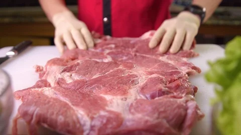 Chef whips a piece of pork to the table Stock Footage 119300541