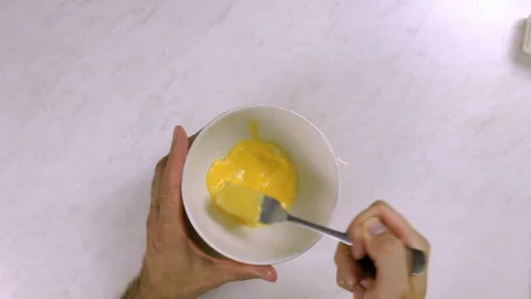 Chef whisking egg with fork Stock Footage 99542992