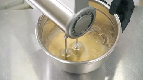 Chef whisks eggs and sugar with mixer to prepare cake Video stock 139487074