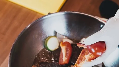 The chef in white gloves add to the dish chopped pepper Stock Footage 73212973