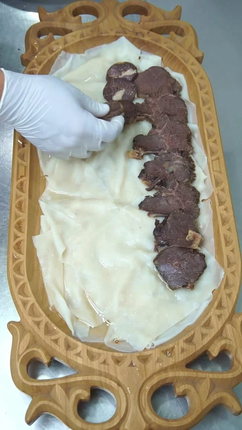 Chef in white gloves arranging sliced horsemeat sausage kazi and boiled beef ove Stock Footage 341352463