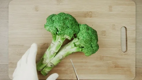Chef in white gloves cutting broccoli for cooking stir fry broccoli concept. Stock Footage 83999341