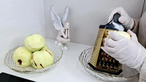 Chef in White Gloves Grating Fresh Peeled Apple with Gold Grater 4K 스톡 동영상 333371213