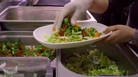 Chef in white gloves preparing Mediterranean salad in  commercial shot Stock Footage 330901552