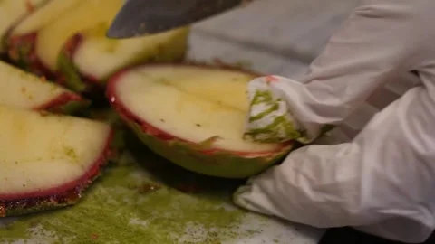 Chef in White Gloves Slicing Fresh Apple with Matcha Green Tea Powder Stock Footage 345292795