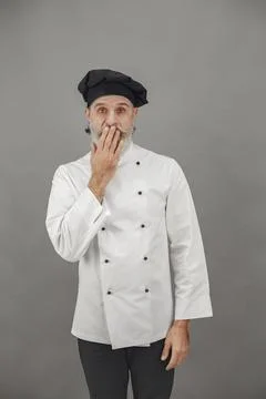 Chef in white uniform over gray background Stock Photos