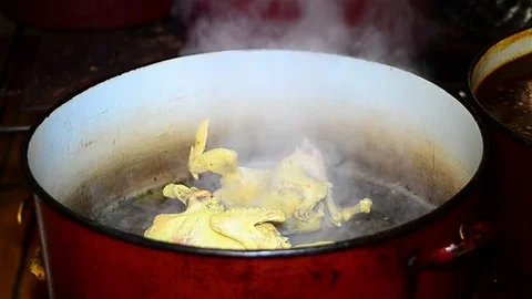 Chef who put in a pot with a ladle, a few chickens that I took out of the soup Stock Footage 72190682