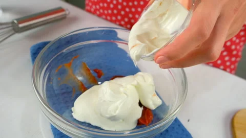 Chef woman hands adding sour cream to bowl with tomato sauce cooking dish. Stock Footage 312400000