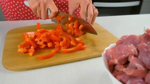 Chef woman hands cooking cutting slicing red sweet pepper on wooden board. Stock Footage 312399853