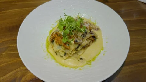 Chef woman serving mashed potato puree using spoon on plate before eating. Food Video stock 299368795