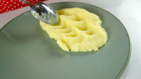 Chef woman serving mashed potato puree using spoon on plate before eating. Stock Footage 312403004