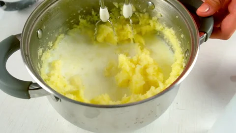Chef woman using electric mixer preparing mashed potato in saucepan on kitchen. Stock Footage 312402964
