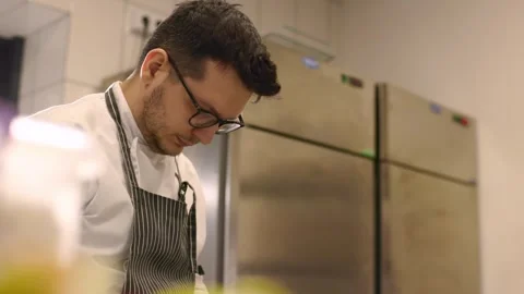 Chef at work. A young male chef works in the kitchen of a restaurant. Stock Footage 277131608