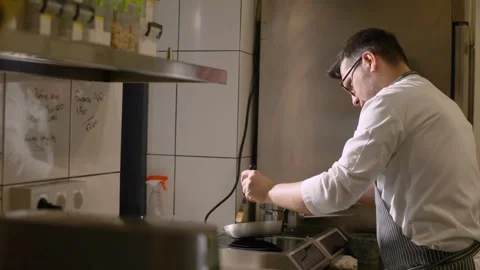 Chef at work. A young male chef works in the kitchen of a restaurant. Stock Footage 277131639