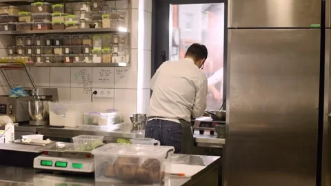 Chef at work. A young male chef works in the kitchen of a restaurant. Video stock 277131875