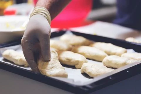 Chef working with dough in bakery. Cooking fancy bread, making delicious past Stock Photos