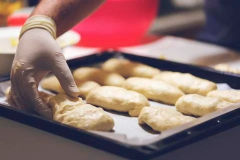 Chef working with dough in bakery. Cooking fancy bread, making delicious past Stock Photos