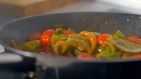 Chef working in the kitchen , mixed colorful vegetables are roasted in a pan. Stock Footage 114623796