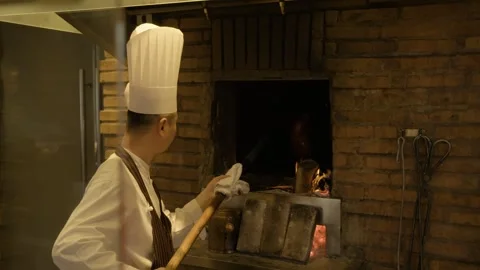 Chef Working at Wood-Fired Oven in Beijing Restaurant Kitchen Preparing Food Stock Footage 345782432