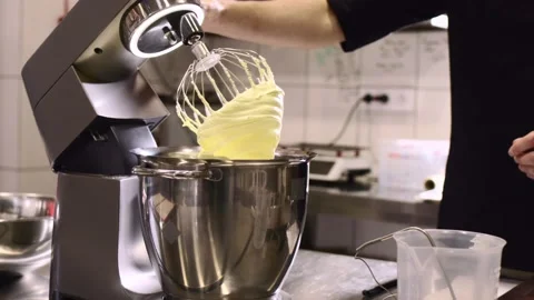 The chef works in the kitchen. The process of making dough for macaroons. Stock Footage 233299061