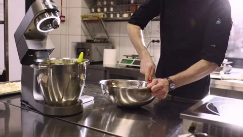 The chef works in the kitchen. The process of making dough for macaroons. Stock Footage 233299062