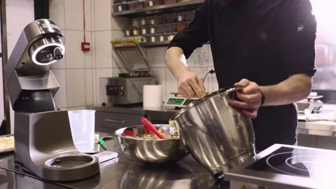 The chef works in the kitchen. The process of making dough for macaroons. Stock Footage 233299111