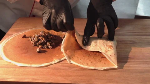 The chef wraps fried minced meat with mushrooms in pancakes Stock Footage 158021916