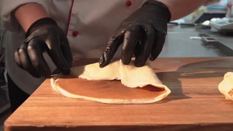 The chef wraps fried minced meat with mushrooms in pancakes Stock Footage 158021917