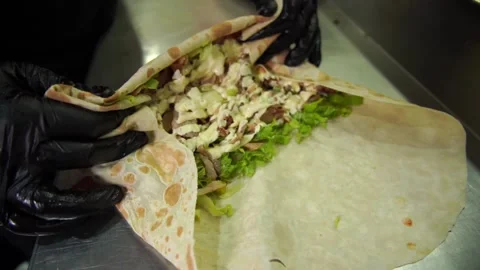 The chef wraps the meat in pita bread Stock Footage 188465311