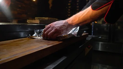 The chef wraps a piece of beef in foil Stock Footage 85670234