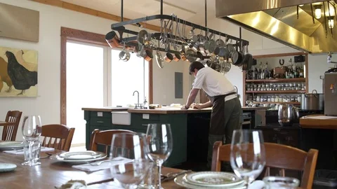 Chef writing at a kitchen table 動画素材 77081545