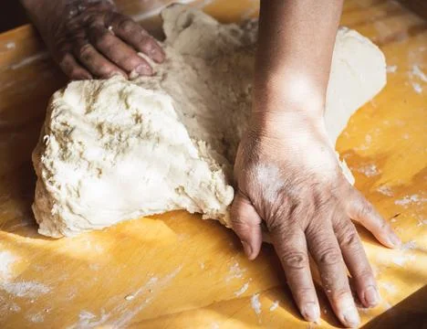 Chef&amp;#039;s Hands Kneading Bread Dough on a Floured Worktop Stock Photos