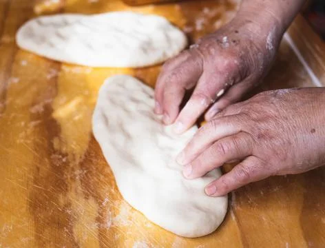 Chef&amp;#039;s Hands Kneading Bread Dough on a Floured Worktop Stock Photos