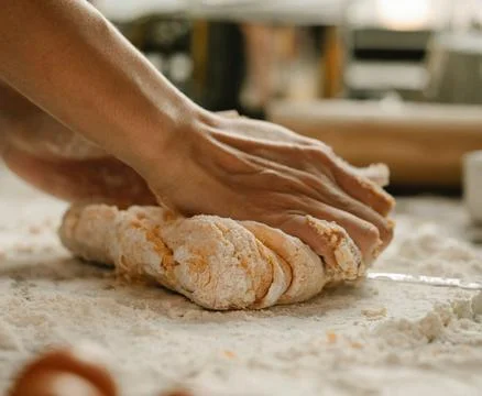 Chef&amp;#039;s Hands Kneading Bread Dough on a Floured Worktop Stock Photos