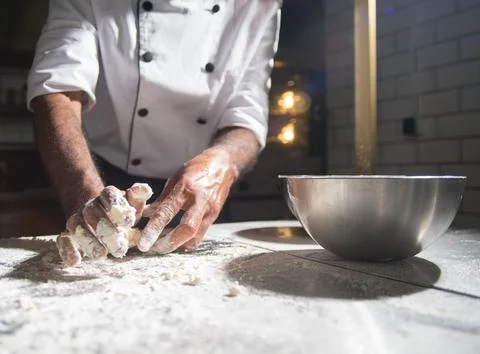 Chef&amp;#039;s Hands Kneading Bread Dough on a Floured Worktop Stock Photos