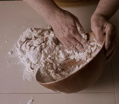 Chef&amp;#039;s Hands Kneading Bread Dough on a Floured Worktop Stock Photos