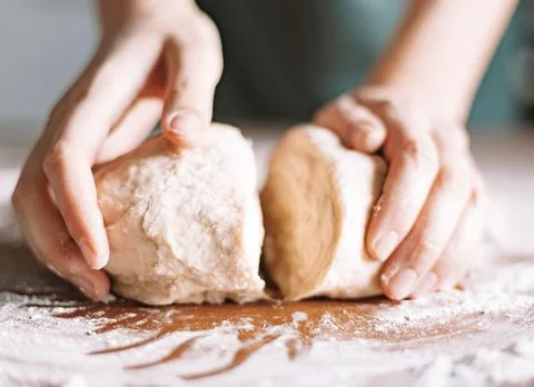 Chef&amp;#039;s Hands Kneading Bread Dough on a Floured Worktop Stock Photos
