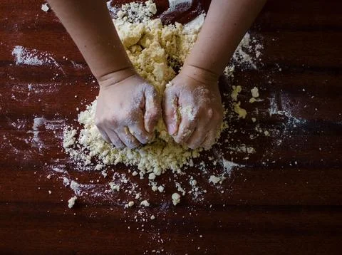 Chef&amp;#039;s Hands Kneading Bread Dough on a Floured Worktop Stock Photos