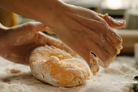 Chef&amp;#039;s Hands Kneading Bread Dough on a Floured Worktop Stock Photos