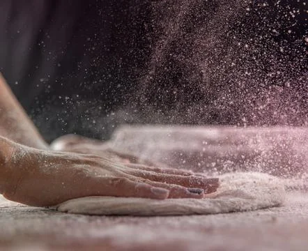 Chef&amp;#039;s Hands Kneading Bread Dough on a Floured Worktop Stock Photos