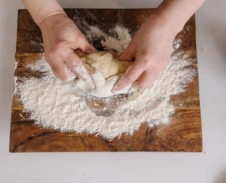 Chef&amp;#039;s Hands Kneading Bread Dough on a Floured Worktop Stock Photos