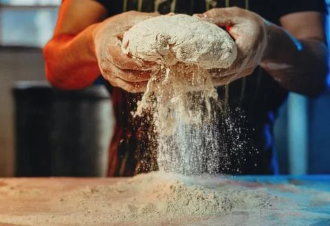 Chef&amp;#039;s Hands Kneading Bread Dough on a Floured Worktop Stock Photos