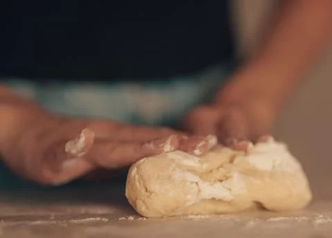 Chef&amp;#039;s Hands Kneading Bread Dough on a Floured Worktop Stock Photos