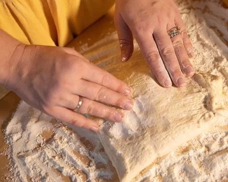 Chef&amp;#039;s Hands Kneading Bread Dough on a Floured Worktop Stock Photos