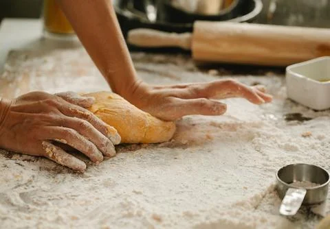 Chef&amp;#039;s Hands Kneading Bread Dough on a Floured Worktop Stock Photos